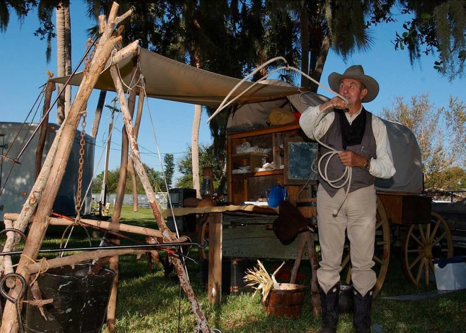 Cowboy historian Hub Hubbell of Sarasota shows off his roping skills in 2002 in front of his covered wagon at the 14th Manatee County Tomato Festival at the Manatee County Fairgrounds in Palmetto.