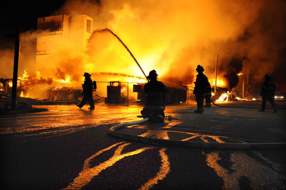 Baltimore firefighters battle a three-alarm fire at Gay and Chester Streets on Monday, April 27, 2015, in Baltimore. It was unclear whether it was related to ongoing riots. (Jerry Jackson/Baltimore Sun/TNS via Getty Images)