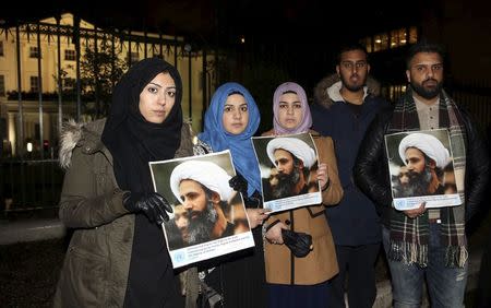 Protesters hold placards as they demonstrate against the execution of prominent Shi'ite cleric Sheikh Nimr al-Nimr outside the Saudi Arabian Embassy in London, Britain January 2, 2016. REUTERS/Neil Hall