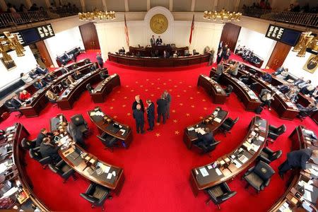 Lawmakers confer during a negotiations on the floor of North Carolina's State Senate chamber as they meet to consider repealing the controversial HB 2 law limiting bathroom access for transgender people in Raleigh, North Carolina, U.S. December 21, 2016. REUTERS/Jonathan Drake