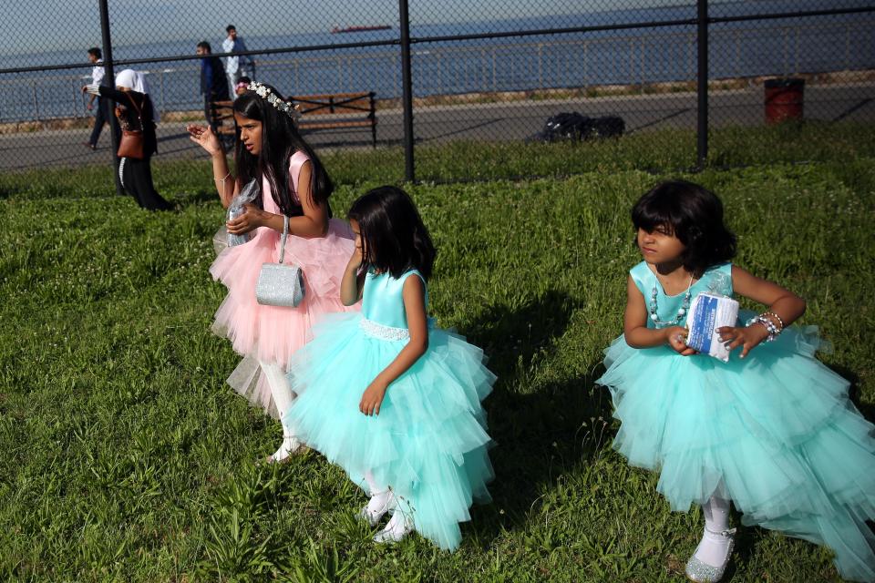 Muslim girls are seen dressed for Eid-ul-Fitr in Bensonhurst Park of Brooklyn borough in New York, United States on June 25, 2017. Eid-al-Fitr is a holiday celebrated by Muslims worldwide that marks the end of Muslims' holy month of fasting 'Ramadan'.