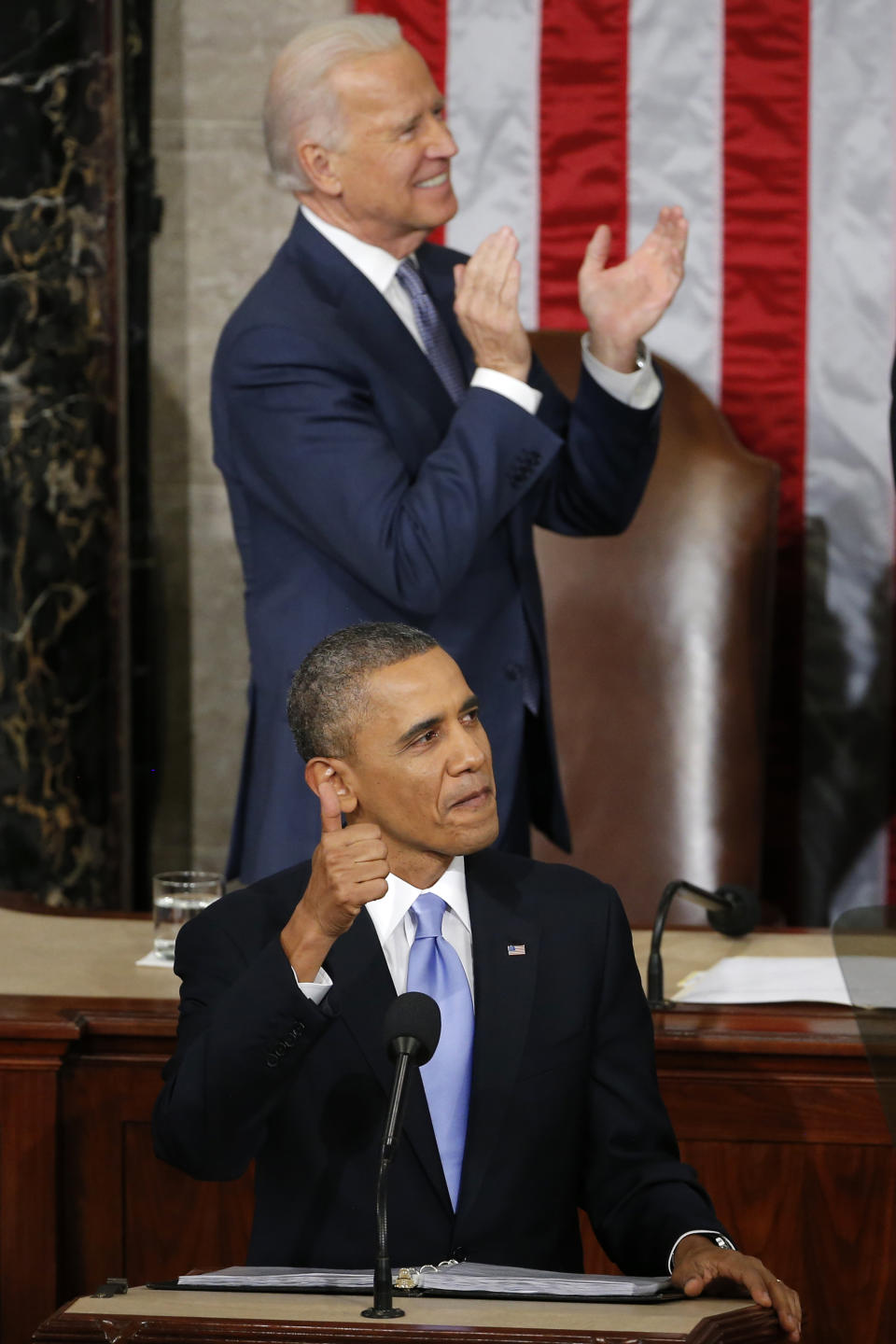 President Barack Obama gives a thumbs-up and Vice President Joe Biden applauds Army Ranger 1st Class Cory Remsburg during the president's State of the Union address on Capitol Hill in Washington, Tuesday Jan. 28, 2014. (AP Photo/Charles Dharapak)