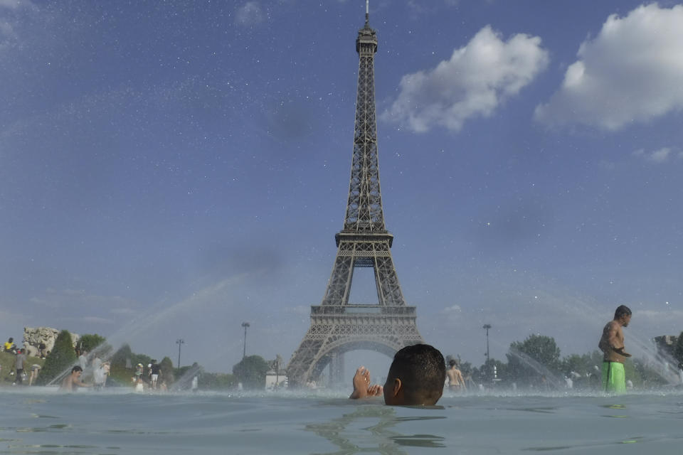 People cool off in the fountain of the Trocadero, in Paris, Tuesday, June 25, 2019. Authorities warned that temperatures could top 40 degrees Celsius (104 Fahrenheit) in some parts of Europe over the coming days, the effect of hot air moving northward from Africa. French Health Minister Agnes Buzyn said more than half of France is on alert for high temperatures Tuesday and the hot weather is expected to last until the end of the week. (AP Photo/Alessandra Tarantino)