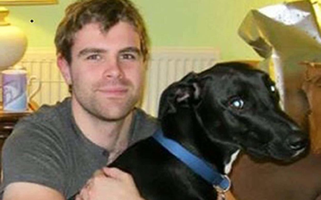 Victim Cameron Logan with his dog, which also died in the attack - PA