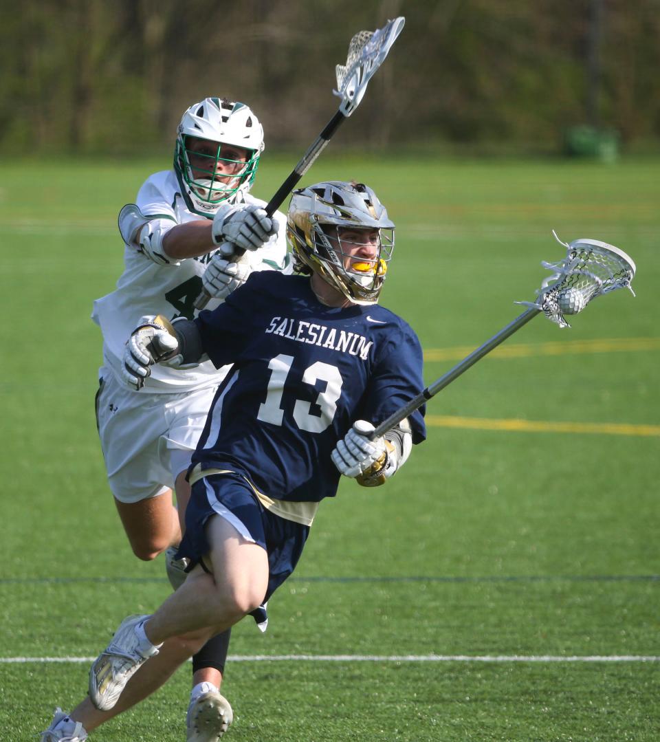 Salesianum's Elliot dotson (13) drives toward the net ahead of Archmere's Alex Passehl in the first half of Salesianum's 17-5 win at Archmere Academy, Wednesday, April 5, 2023.