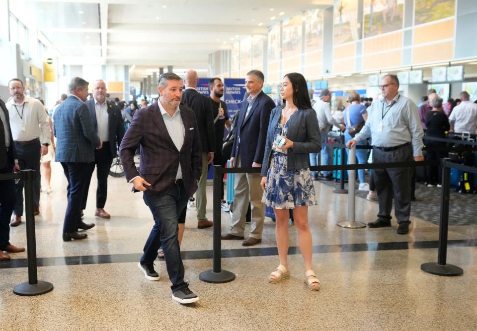 Cruz arrives to speak Tuesday at a news conference in the airport.