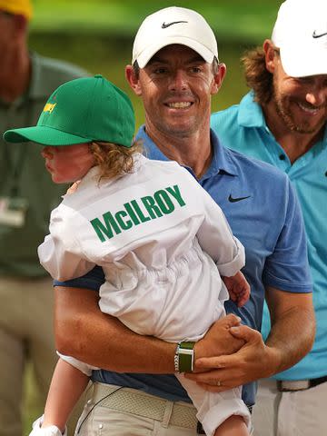 <p>Erick W. Rasco/Sports Illustrated/Getty</p> Rory McIlroy and his daughter Poppy during the Par 3 Contest prior to the 2023 Masters Tournament.