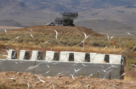 Military equipment is visible from the entrance to Area 51 as an influx of tourists responding to a call to 'storm' Area 51, a secretive U.S. military base believed by UFO enthusiasts to hold government secrets about extra-terrestrials, is expected