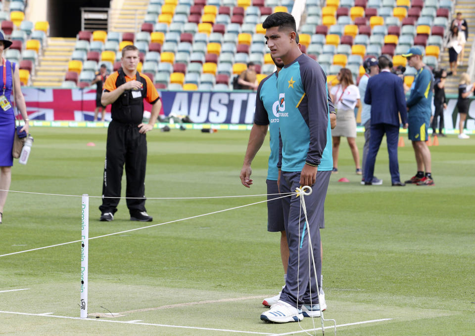 Pakistan's 16 year old Naseem Shah inspects the pitch before the first cricket test match in Brisbane, Australia, Thursday, Nov. 21 2019. (AP Photo/Tertius Pickard)