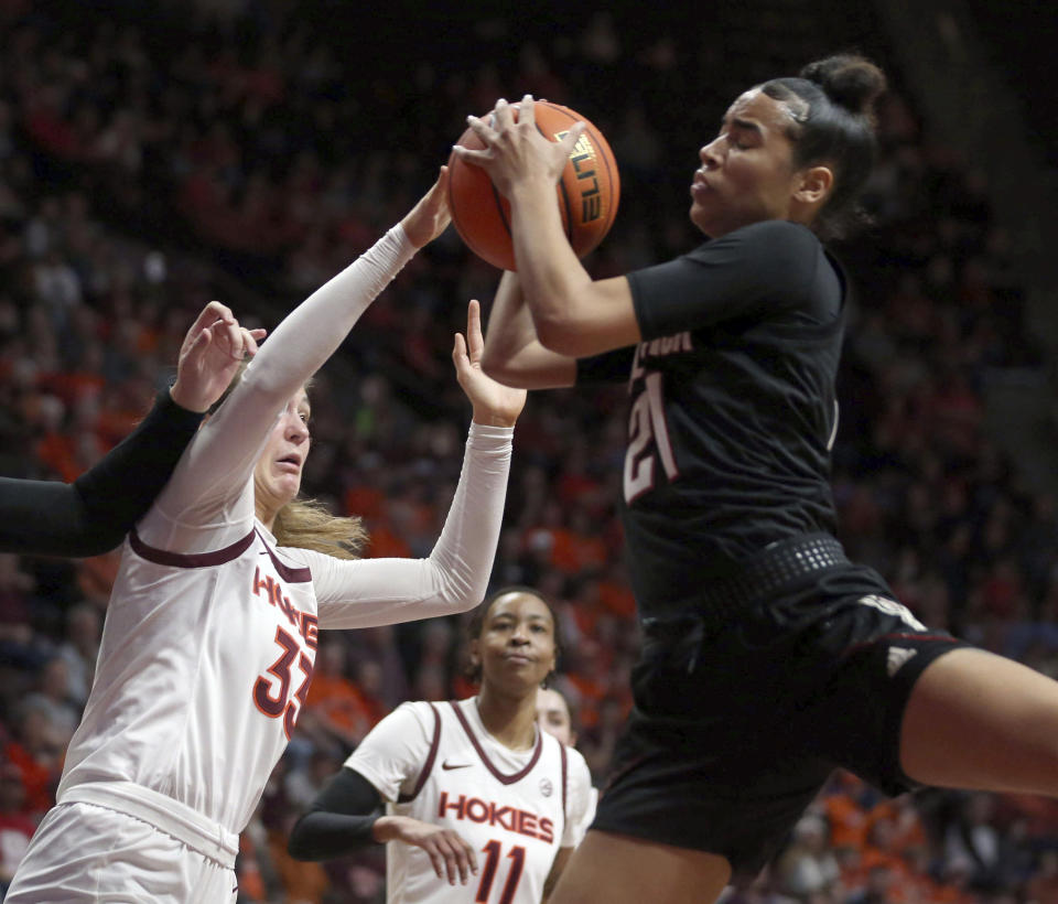 North Carolina State's Madison Hayes, right, grabs an offensive rebound in front of Virginia Tech's Elizabeth Kitley, left, during the first half of an NCAA college basketball game Sunday, Feb. 19, 2023, in Blacksburg, Va. (Matt Gentry/The Roanoke Times via AP)