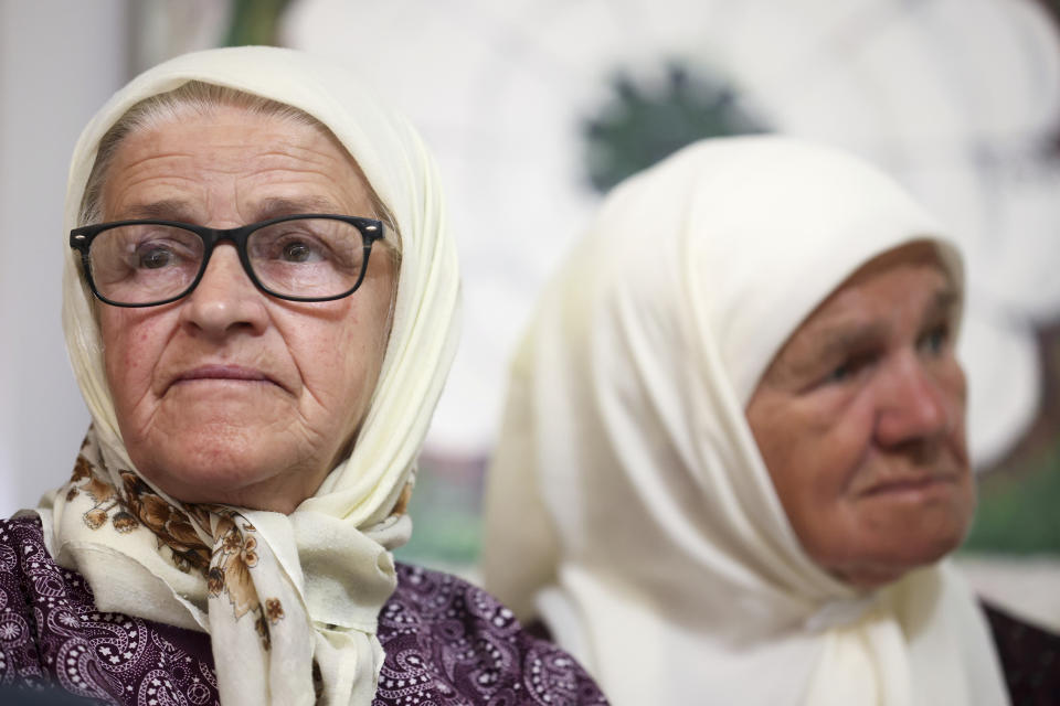 Fatima Salihovic, left, member of the association Mothers of Srebrenica watches the United Nations General Assembly session where voting on a draft resolution declaring July 11 the International Day of Reflection and Commemoration of the 1995 genocide in Srebrenica takes place, in Potocari, Bosnia, Thursday, May 23, 2024. (AP Photo/Armin Durgut)