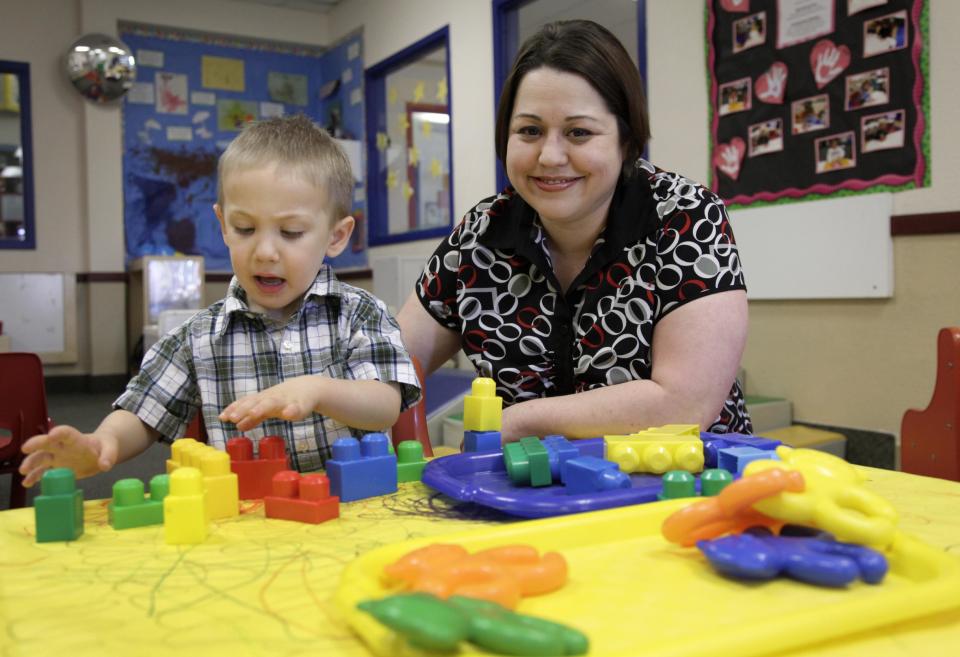 In this April 4, 2012, photo, Kelly Andrus plays with her son Bradley, in his classroom at Children's Choice Learning Centers Inc., in Lewisville, Texas. Bradley, who turns three in a couple of weeks, was diagnosed a year ago with mild autism. For the first time in nearly two decades, experts want to rewrite the definition of autism. Some parents fear that if it's narrowed and their kids lose the label, they may also lose out on special therapist. (AP Photo/Tony Gutierrez)