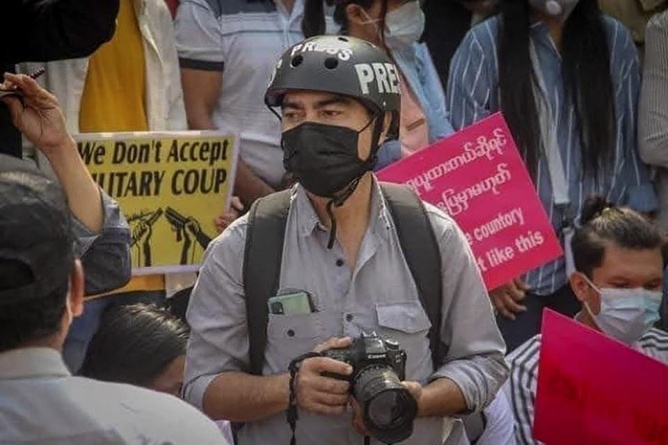 In this undated photo provided by the Democratic Voice of Burma (DVB), journalist Min Nyo covers an anti-coup protest in Pyay, Myanmar. Min Nyo, a correspondent for the online and broadcast news agency DVB, was sentenced on May 12, 2021 by a Myanmar military court to three years in prison for his reporting. (Democratic Voice of Burma via AP)