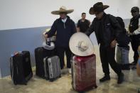 The folklore music group "Misquillahualy," from the Mexican state of Hidalgo, waits for a new flight to Colombia after theirs was canceled during a a global technology outage at Benito Juárez International Airport in Mexico City, Friday, July 19, 2024. (AP Photo/Marco Ugarte)