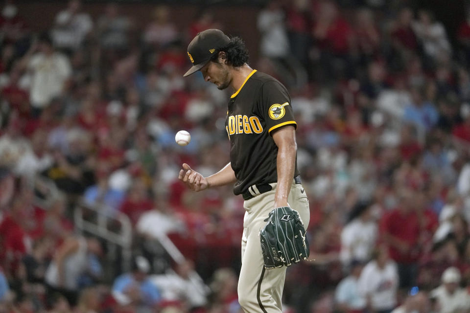 San Diego Padres starting pitcher Yu Darvish tosses a ball on the mound during the fourth inning of a baseball game against the St. Louis Cardinals Saturday, Sept. 18, 2021, in St. Louis. (AP Photo/Jeff Roberson)