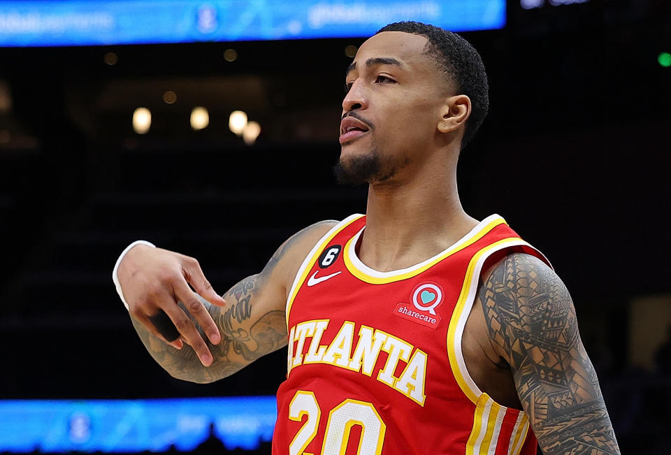 ATLANTA, GEORGIA - FEBRUARY 11:  John Collins #20 of the Atlanta Hawks reacts after a three-point basket against Keita Bates-Diop #31 of the San Antonio Spurs during the fourth quarter at State Farm Arena on February 11, 2023 in Atlanta, Georgia.  NOTE TO USER: User expressly acknowledges and agrees that, by downloading and or using this photograph, User is consenting to the terms and conditions of the Getty Images License Agreement.  (Photo by Kevin C. Cox/Getty Images)