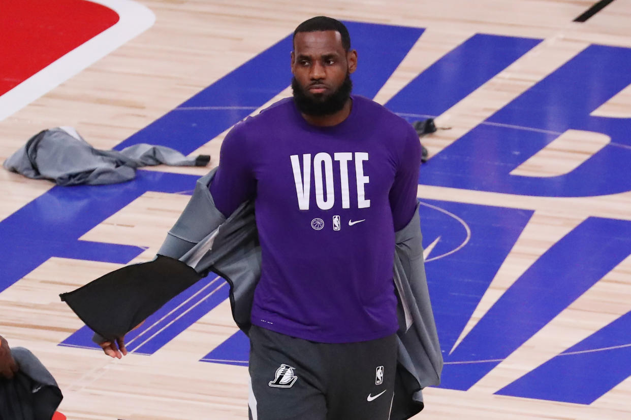 LAKE BUENA VISTA, FLORIDA - OCTOBER 09: LeBron James #23 of the Los Angeles Lakers wears a VOTE shirt during warm-up prior to the start of the game against the Miami Heat in Game Five of the 2020 NBA Finals at AdventHealth Arena at the ESPN Wide World Of Sports Complex on October 9, 2020 in Lake Buena Vista, Florida. NOTE TO USER: User expressly acknowledges and agrees that, by downloading and or using this photograph, User is consenting to the terms and conditions of the Getty Images License Agreement. (Photo by Sam Greenwood/Getty Images)