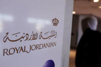 A traveler walks past a sign for Royal Jordanian airline at JFK International Airport in New York, U.S., March 21, 2017. REUTERS/Lucas Jackson