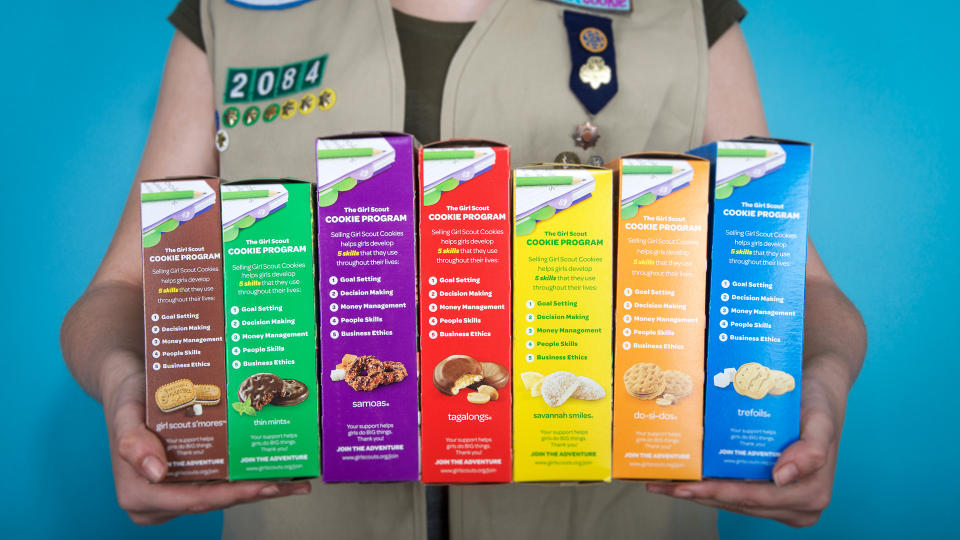 Girl Scout holding girl scout cookies