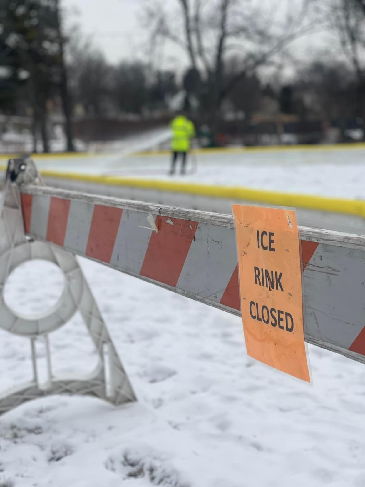 A worker repairs the damaged ice rink at Cedar Creek Park in Cedarburg.