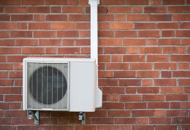 A heat pump on a brick wall (Photo: Getty)