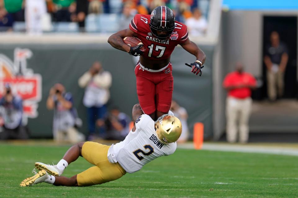 South Carolina Gamecocks wide receiver Xavier Legette (17) is tackled by Notre Dame Fighting Irish safety DJ Brown (2) during the first quarter of the TaxSlayer Gator Bowl of an NCAA college football game Friday, Dec. 30, 2022 at TIAA Bank Field in Jacksonville. The Notre Dame Fighting Irish held off the South Carolina Gamecocks 45-38. [Corey Perrine/Florida Times-Union]

Jki 123022 Ncaaf Nd Usc Cp 70