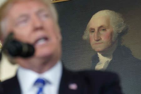 A portrait of U.S. President George Washington is seen over the shoulder of U.S. President Donald Trump as he speaks about his recent trip to Asia in the Diplomatic Room of the White House in Washington, U.S., November 15, 2017. REUTERS/Joshua Roberts
