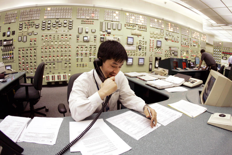 FILE - In this April 20, 2007, file photo, Tracy Sudoko, a control room agent at the Indian Point Energy Center, works on a report at the facility in Buchanan, N.Y. Indian Point will permanently stop producing nuclear power Friday, April 30, 2021, capping a long battle over a key source of electricity for nearby New York City that opponents called a safety threat to millions in the densely packed metropolitan region. (AP Photo/Julie Jacobson, File)