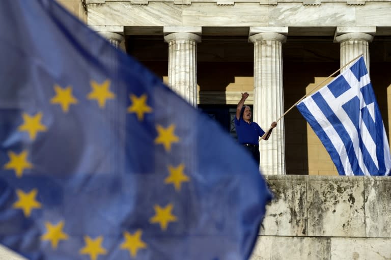 A protester shouts slogans during a pro-European demonstration in front of the Greek parliament in Athens