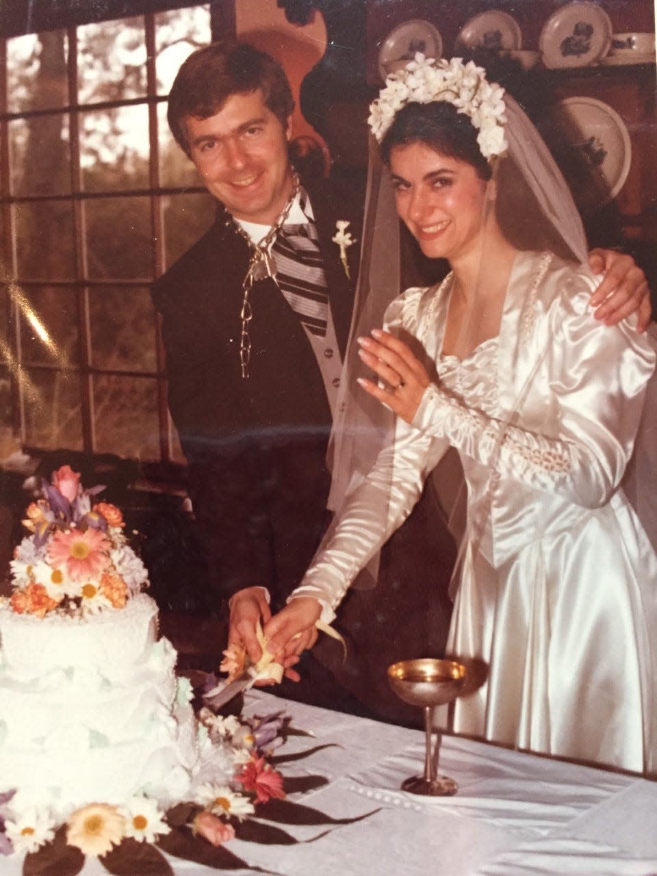 Michael and Mary Easley cut the cake on their wedding day.