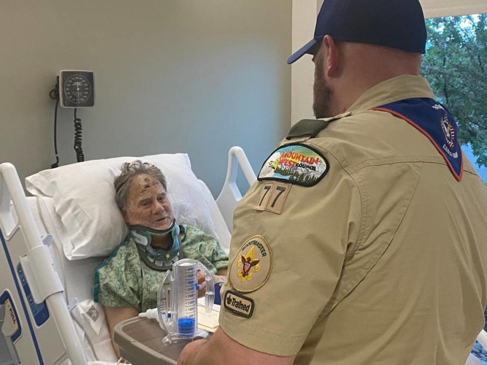 Eric Valentine talks to one of Troop 77’s Scoutmasters from his hospital bed Monday evening. Nearly two dozen members of the troop were out on a canoe trip in May 6 when they were flagged down and able to help Valentine after he fell off a hill.