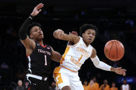 Tennessee guard Kennedy Chandler and Texas Tech guard Terrence Shannon Jr. watch the ball during the first half of an NCAA college basketball game in the Jimmy V Classic on Tuesday, Dec. 7, 2021, in New York. (AP Photo/Adam Hunger)