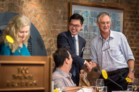 Victor Mallet, Financial Times journalist and first vice president of the Foreign Correspondents' Club (FCC), shakes hands with Andy Chan, founder of the Hong Kong National Party, during a luncheon at the FCC in Hong Kong, China, August 14, 2018. Picture taken August 14, 2018. Paul Yeung/Pool via REUTERS