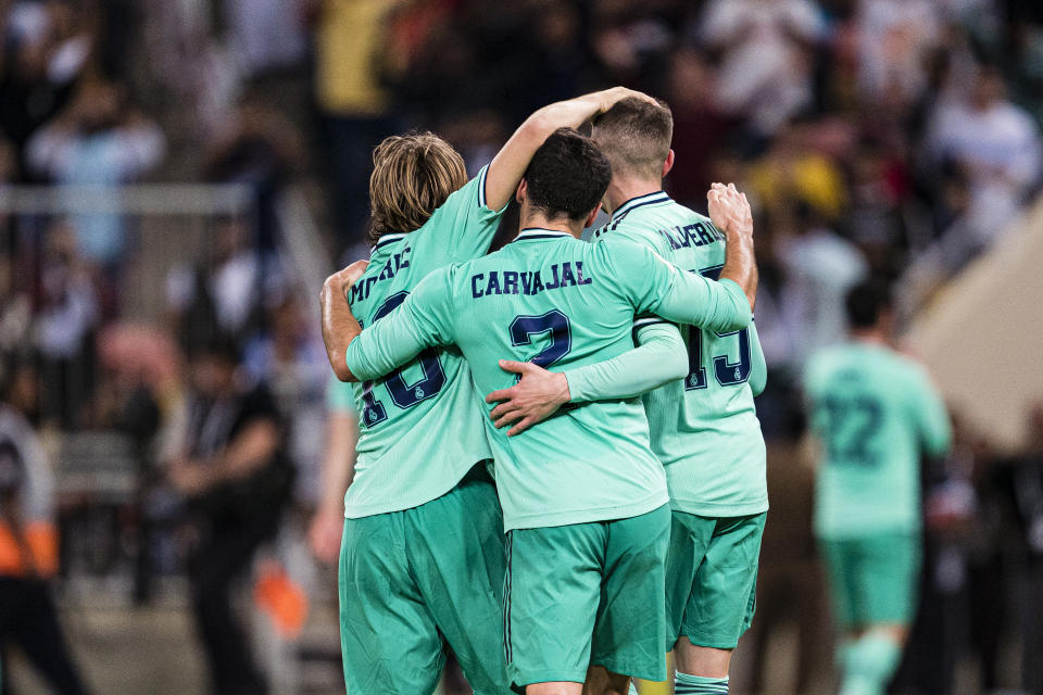 JEDDAH, SAUDI ARABIA - JANUARY 08: Luka Modric (L), Daniel Carvaja (C) and Santiago Valverde of Real Madrid (R) celebrating Isco"u2019s goal during the Supercopa de Espana Semi-Final match between Valencia CF and Real Madrid at King Abdullah Sports City on January 8, 2020 in Jeddah, Saudi Arabia. (Photo by Eurasia Sport Images/Getty Images)