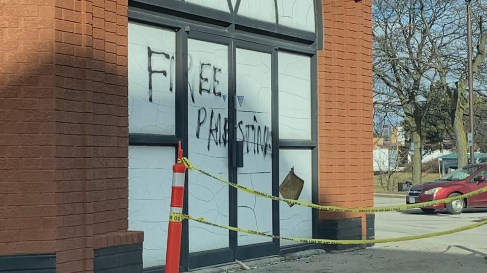 Graffiti reading 'Free Palestine' was left on the rear doors of a Jewish grocer in North York after an early morning fire there on Wednesday.