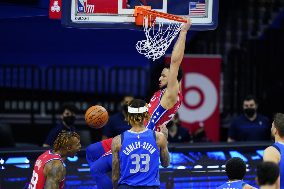 Philadelphia 76ers' Ben Simmons, top, dunks the ball against Dallas Mavericks' Willie Cauley-Stein during the first half of an NBA basketball game, Thursday, Feb. 25, 2021, in Philadelphia. (AP Photo/Matt Slocum)