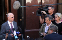 Oscar Pistorius's uncle Arnold Pistorius, reads a statement outside the high court in Pretoria, South Africa, Wednesday, May 14, 2014. Pistorius is charged with murder for the shooting death of his girlfriend, Reeva Steenkamp, on Valentines Day in 2013. A judge ruled on Wednesday, that Oscar Pistorius be sent for psychiatric observation. (AP Photo/Themba Hadebe)