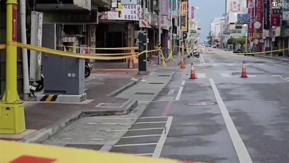 In this image from a video, roads in Hualien, Taiwan are cordoned off after a cluster of earthquakes struck the island early Tuesday, April 23, 2024. There were no reports of casualties in the quakes, although there were further damages to two multi-story buildings that had been evacuated following a magnitude 7.4 quake that hit the island earlier this month, killing 13 people and injuring over 1,000. (TVBS via AP)