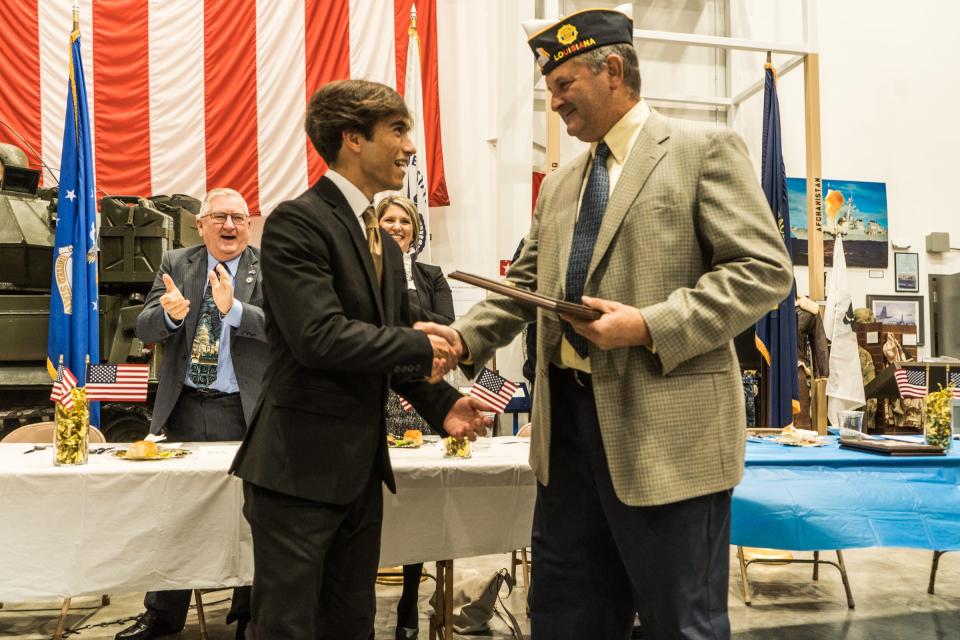 American Legion 3rd District Area Commander Lee Shaffer presents the Teenager of the Year award to Evan Blanchard.