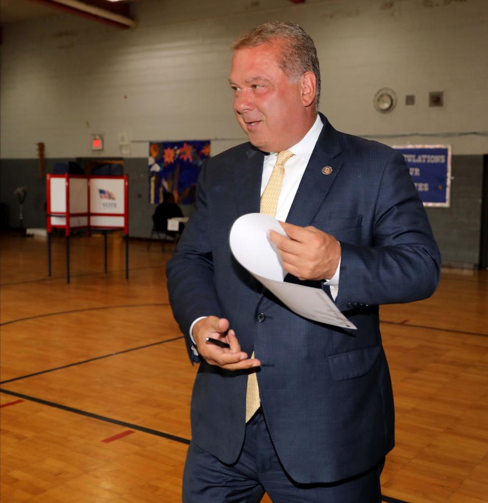 Yonkers Mayor Mike Spano walks with the ballot for the Democratic primary, as he votes at the Khalil Gibran school in Yonkers, June 27, 2023.