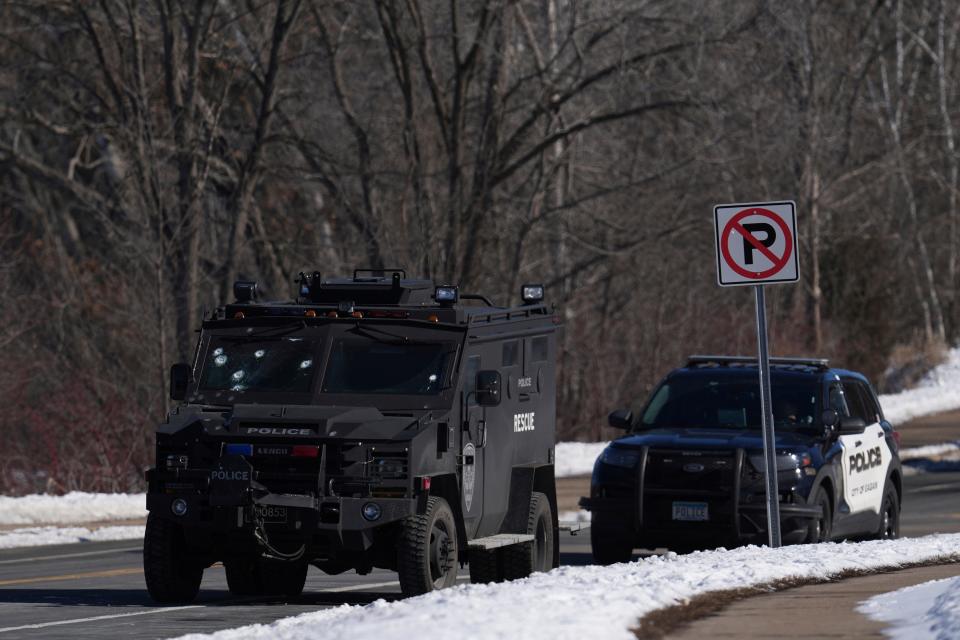 A police vehicle with what appears to be bullet pockmarks on its windshield is parked near the scene where two police officers and a first responder were shot and killed Sunday, Feb. 18, 2024, in Burnsville, Minn.