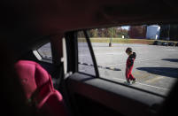 A five-year-old boy walks outside his mother's car after they arrive to visit his uncle at the Stewart Detention Center, Sunday, Nov. 10, 2019, in Lumpkin, Ga. The boy's father was deported to Mexico a year ago from the same ICE facility where his uncle is now detained. "He had never been separated from his dad. He was always there from day one," said his mother, Lucia, who asked that her real name not be used. "He would tell the immigration officer, just take my daddy out. I'll be a good boy." (AP Photo/David Goldman)