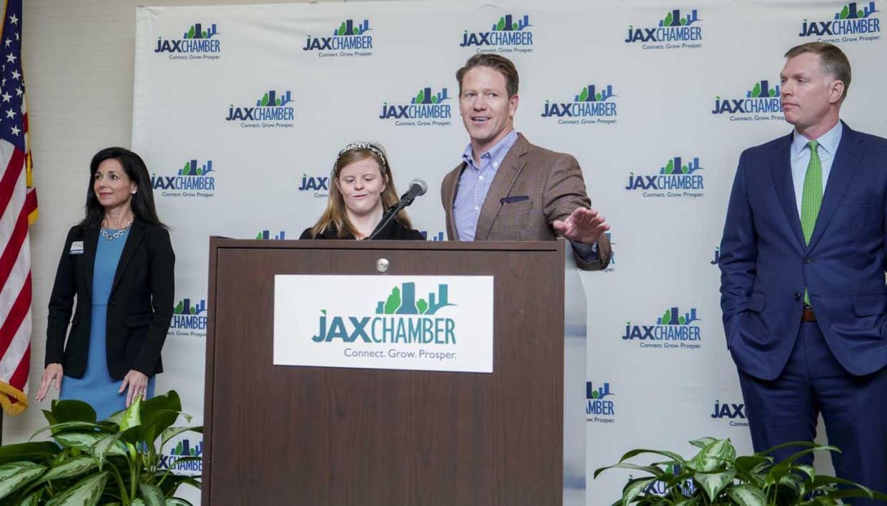 JAX Chamber CEO Daniel Davis, standing at the podium while announcing a chamber hiring initiative, will continue to work as the chamber's top executive while he runs for Jacksonville mayor.