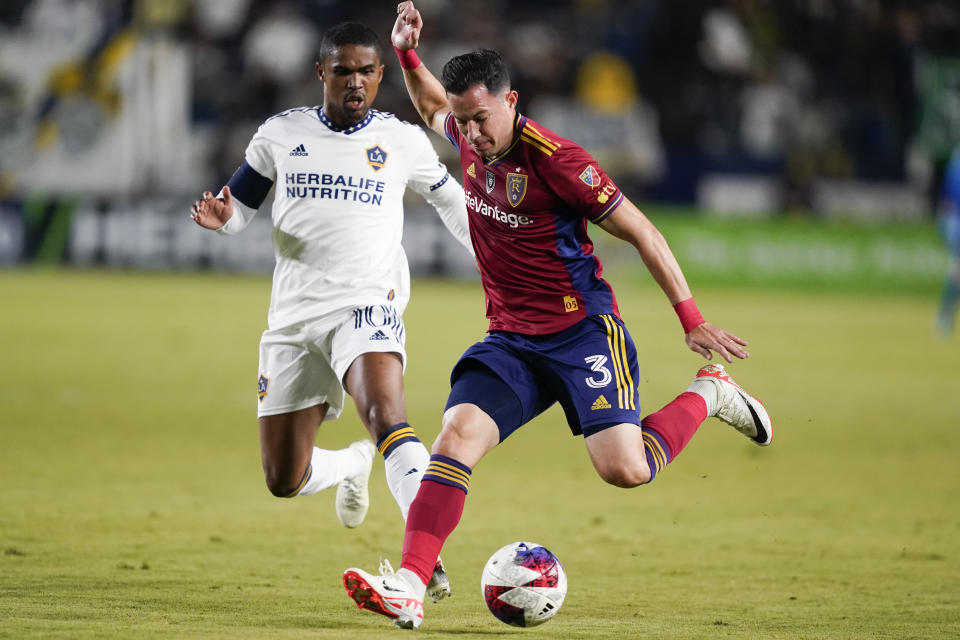 Real Salt Lake defender Bryan Oviedo (3) controls the ball as LA Galaxy forward Douglas Costa (10) chases during the first half of an MLS soccer match Saturday, Oct. 14, 2023, in Carson, Calif. (AP Photo/Ryan Sun)