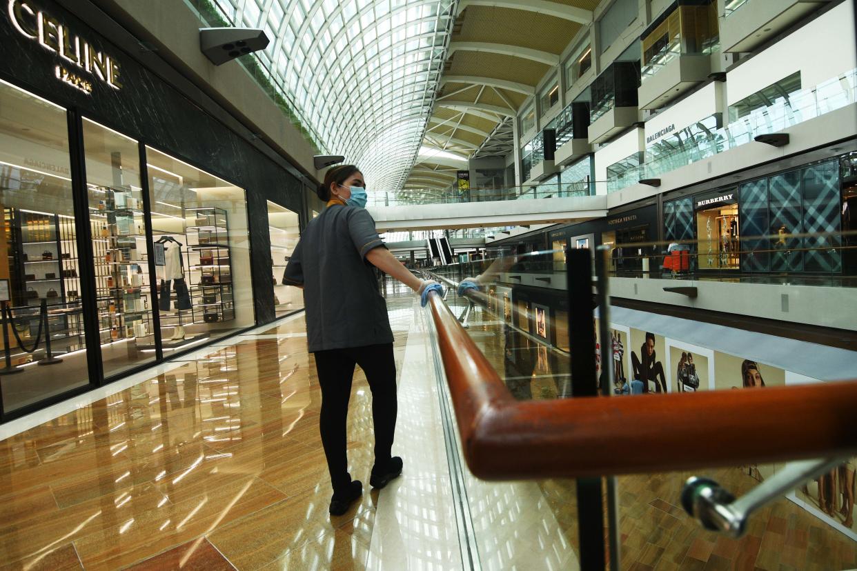 SINGAPORE, June 19, 2020-- A worker wearing a face mask cleans a handrail at a shopping mall in Singapore, on June 19, 2020. Singapore has entered phase two of re-opening after 11:59 p.m. June 18. (Photo by Then Chih Wey/Xinhua via Getty) (Xinhua/ via Getty Images)