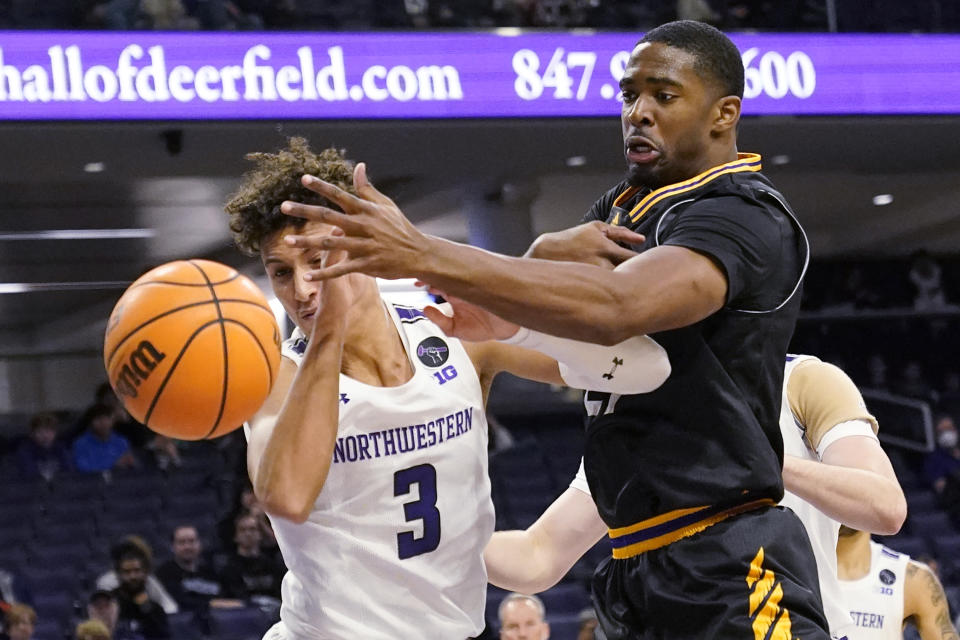 Northwestern guard Ty Berry, left, and Prairie View A&M forward Nikkei Rutty battle for a rebound during the first half of an NCAA college basketball game in Evanston, Ill., Sunday, Dec. 11, 2022. (AP Photo/Nam Y. Huh)