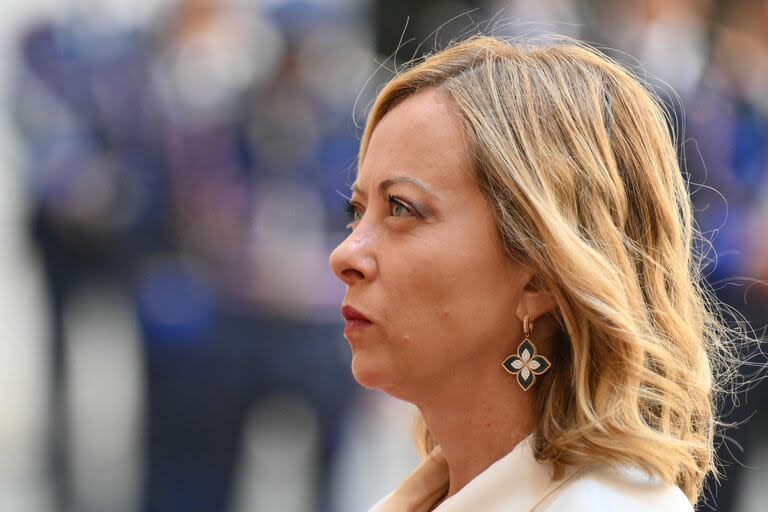 Italy’s Prime Minister Giorgia Meloni waits to greet Israel's President Isaac Herzog at the Chigi Palace in Rome on July 25, 2024. (Photo by Alberto PIZZOLI / AFP)