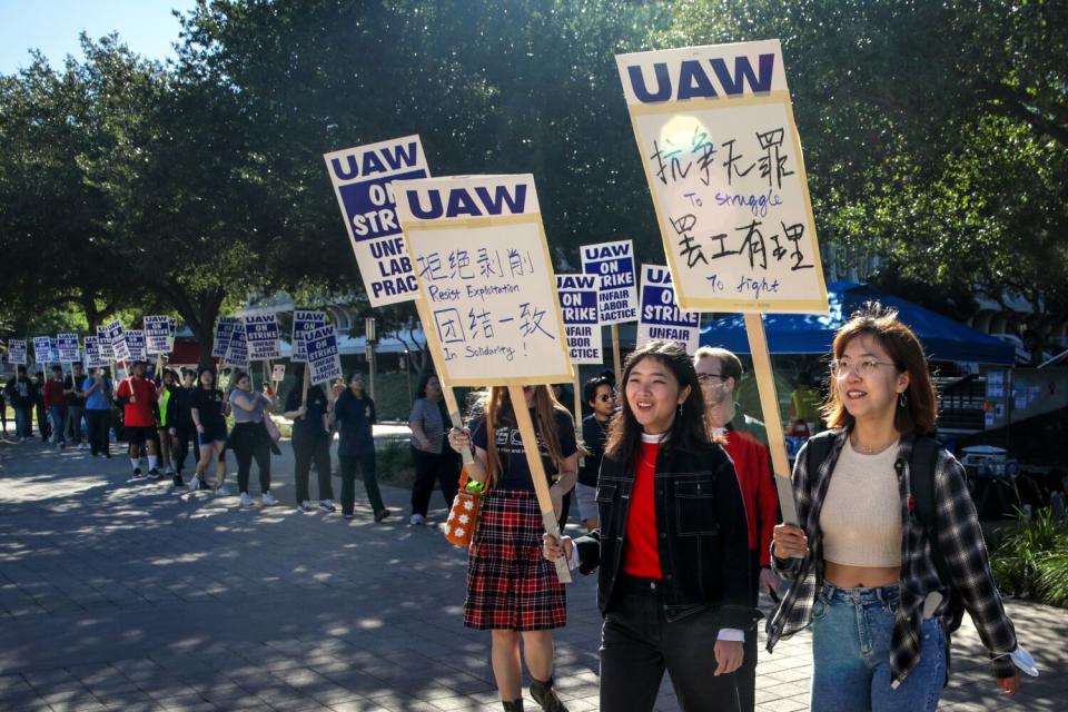 A long line of unionized academic workers picket at a rally at University of California Irvine