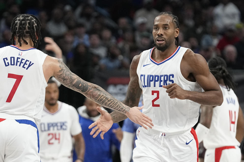 Los Angeles Clippers forward Kawhi Leonard (2) is congratulated by teammate guard Amir Coffey (7) after Leonard scored during the second half of an NBA basketball game against Dallas Mavericks in Dallas, Wednesday, Dec. 20, 2023. (AP Photo/LM Otero)