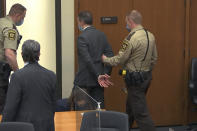 In this image from video, former Minneapolis police officer Derek Chauvin is taken into custody as his attorney Eric Nelson, left, watches, after his bail was revoked after he was found guilty on all three counts in his trial for the 2020 death of George Floyd, Tuesday, April 20, 2021, at the Hennepin County Courthouse in Minneapolis. (Court TV via AP, Pool)